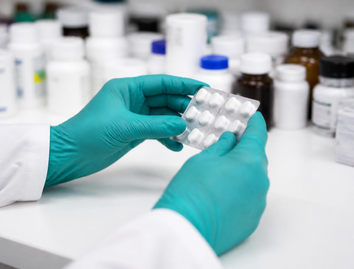 Pharmacist inspecting medicine packs during a quality check